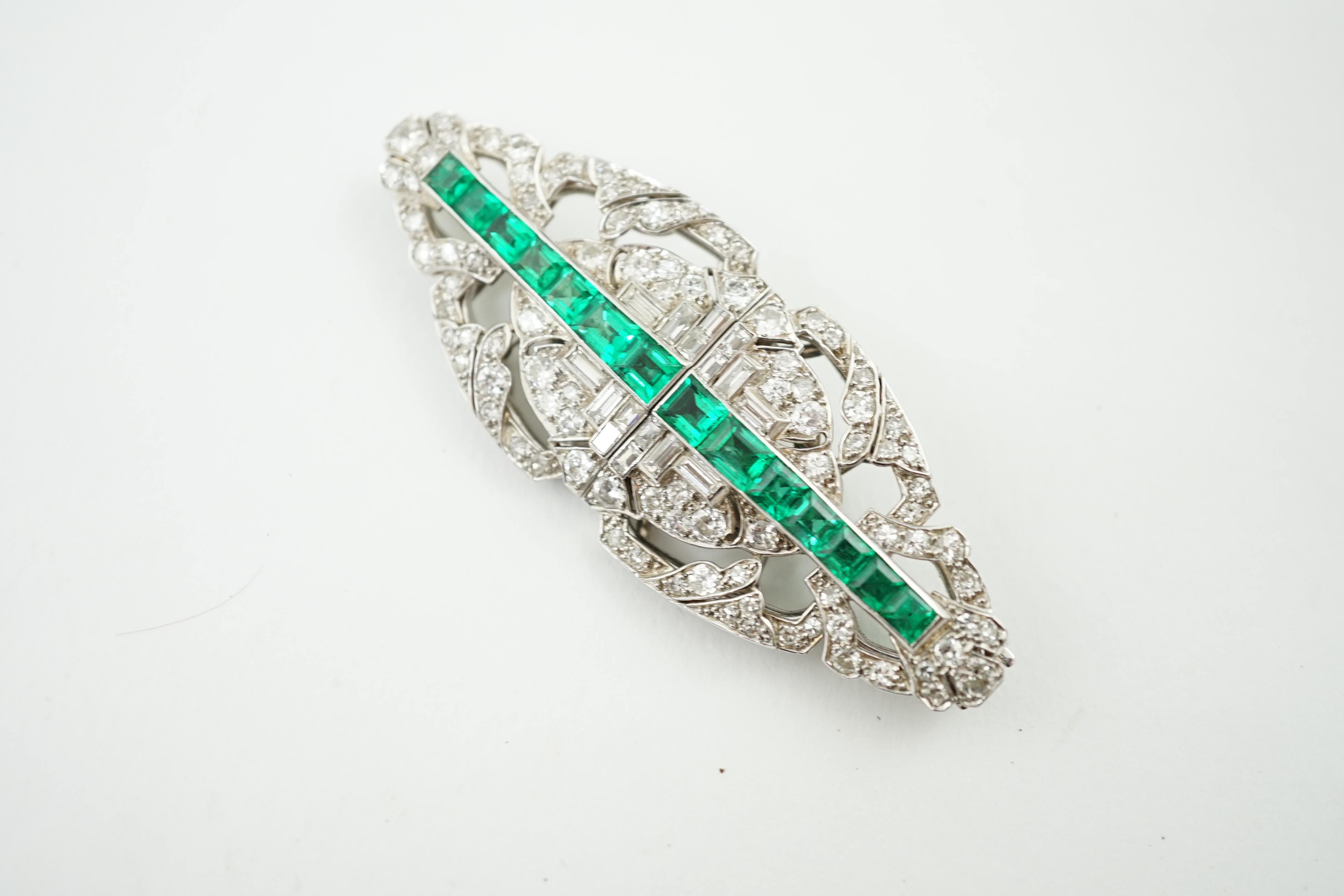 A 1930's/1940's white gold, emerald and diamond double clip brooch